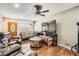 Inviting living room featuring wood floors, a ceiling fan, and ample space for entertaining guests at 15685 E 50Th Ave, Denver, CO 80239