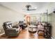 Spacious living room with comfortable seating, wood flooring, and a view of the front entrance at 15685 E 50Th Ave, Denver, CO 80239