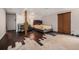 Unfinished basement features a bedroom area, exposed beams, and a closet with sliding doors at 1572 W Long Ave, Littleton, CO 80120
