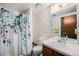Bathroom with a floral shower curtain and a vanity with ample counter space at 1572 W Long Ave, Littleton, CO 80120