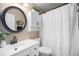 Bathroom featuring a white vanity, mirror, and a shower with a white waffle curtain at 1572 W Long Ave, Littleton, CO 80120
