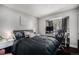 Bedroom with a large bed, desk, and window offering ample natural light at 1572 W Long Ave, Littleton, CO 80120