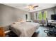 Bedroom featuring a ceiling fan, and a large window that provides ample natural light at 1572 W Long Ave, Littleton, CO 80120