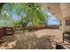 Wooden deck with an outdoor seating area surrounded by mature trees and string lights at 1572 W Long Ave, Littleton, CO 80120