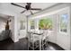 Bright dining area featuring a bay window with backyard views and modern ceiling fan at 1572 W Long Ave, Littleton, CO 80120