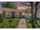 Charming brick and siding home with a well-manicured front yard and a welcoming entrance with flower boxes at 1572 W Long Ave, Littleton, CO 80120