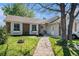 Charming home featuring a brick facade, well-maintained lawn, and inviting walkway leading to the front entrance at 1572 W Long Ave, Littleton, CO 80120
