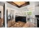 Kitchen with stainless steel refrigerator and granite countertops, providing an open view to the dining area at 1572 W Long Ave, Littleton, CO 80120