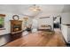 Open living room features a brick fireplace, ceiling fan, and large windows offering ample natural light at 1572 W Long Ave, Littleton, CO 80120