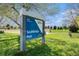 Southbridge Park sign with a green lawn and baseball field in the background at 1572 W Long Ave, Littleton, CO 80120