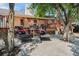 Outdoor patio with black wicker chairs, a table with flowers, and a view of the backyard at 1572 W Long Ave, Littleton, CO 80120