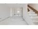 Bright basement with a staircase, white walls, and unfinished floors, ready to be renovated at 226 Ash St, Bennett, CO 80102
