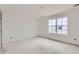 An unfinished bedroom with a window, ready to customize and create your personal space at 226 Ash St, Bennett, CO 80102