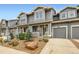Charming townhome featuring a gray exterior, landscaped front yard, and attached one-car garage at 226 Ash St, Bennett, CO 80102