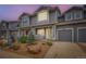 Charming townhome featuring a gray exterior, landscaped front yard, and attached one-car garage at 226 Ash St, Bennett, CO 80102