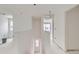 Open hallway area with stairway, featuring bright, naturally lit areas awaiting your personal design choices at 226 Ash St, Bennett, CO 80102