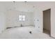 Unfinished kitchen featuring white walls, a bright window and recessed lighting, awaiting your custom design at 226 Ash St, Bennett, CO 80102