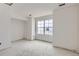 Bright living room with ample natural light from the large window, ready for your custom finishes at 226 Ash St, Bennett, CO 80102