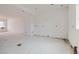 Open concept living room with white walls under construction and recessed lighting, ready for personalization at 226 Ash St, Bennett, CO 80102