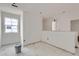 Bright living room with ample natural light from the large window, ready for your custom finishes at 226 Ash St, Bennett, CO 80102