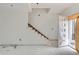 Unfinished staircase featuring bare wood, awaiting your custom design, and a covered front door at 226 Ash St, Bennett, CO 80102