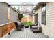 A covered patio is set up with comfortable seating and a fire pit, creating an inviting outdoor space at 2939 Osceola St, Denver, CO 80212
