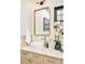 Bathroom vanity with marble countertops, modern fixtures, white sink, and a decorous flower vase at 2939 Osceola St, Denver, CO 80212