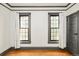 Bright bedroom features hardwood floors, ample windows, and gray trim, creating a serene and inviting space at 2939 Osceola St, Denver, CO 80212