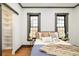 Bedroom with storage rack, hardwood floors, and large windows bringing in lots of light at 2939 Osceola St, Denver, CO 80212
