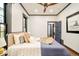 Bedroom showcasing a comfortable bed, ceiling fan, and an inviting view of the interior decor at 2939 Osceola St, Denver, CO 80212