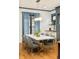 Stylish dining room featuring hardwood floors, modern lighting, and elegant blue accents at 2939 Osceola St, Denver, CO 80212