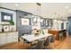 Open concept dining area with modern lighting, fireplace, and seamless flow to the kitchen at 2939 Osceola St, Denver, CO 80212