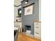 Elegant fireplace with gray brick, complemented by built-in cabinets and stylish decor at 2939 Osceola St, Denver, CO 80212
