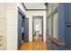 Hallway includes hardwood floors and ample storage with charming blue accents at 2939 Osceola St, Denver, CO 80212