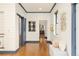 Hallway features hardwood floors, shiplap walls, and a glimpse into other rooms at 2939 Osceola St, Denver, CO 80212