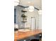 Modern kitchen featuring wood island, sleek countertops, and open shelving with pendant lights above the island at 2939 Osceola St, Denver, CO 80212