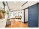 Open-concept living room with a sliding barn door, hardwood floors, and natural light at 2939 Osceola St, Denver, CO 80212