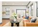 Living room with hardwood floors, a leather sofa, and sliding doors leading to outdoor space at 2939 Osceola St, Denver, CO 80212