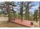 Secluded outdoor deck nestled among trees, offering a tranquil retreat with built-in seating at 2063 Montane E Dr, Golden, CO 80401