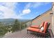 Outdoor deck with chaise lounges offers beautiful views of the mountains and clear skies at 2063 Montane E Dr, Golden, CO 80401