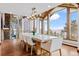 Bright dining room with large windows, mountain views and modern chandelier lighting at 2063 Montane E Dr, Golden, CO 80401