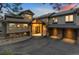 Stunning exterior showcasing a custom home with a stone facade, three-car garage, and a dramatic entrance at 2063 Montane E Dr, Golden, CO 80401