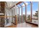 Spacious foyer with a stone fireplace, hardwood floors, and a wall of windows with stunning mountain views at 2063 Montane E Dr, Golden, CO 80401