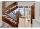Bright foyer featuring a hardwood staircase, large windows offering scenic views, and access to the office at 2063 Montane E Dr, Golden, CO 80401