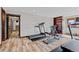Spacious home gym featuring wood laminate flooring, treadmills, and exercise equipment at 2063 Montane E Dr, Golden, CO 80401