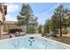 Inviting hot tub and outdoor patio area perfect for relaxation and enjoying scenic mountain views and lush landscaping at 2063 Montane E Dr, Golden, CO 80401