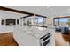 Spacious kitchen with a large marble island, modern appliances, and a seamless transition to the dining area at 2063 Montane E Dr, Golden, CO 80401
