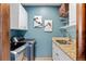 Functional laundry room with modern appliances, granite countertop, and ample storage space at 2063 Montane E Dr, Golden, CO 80401