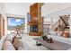 Bright living room featuring a stone fireplace, plush seating, and mountain views at 2063 Montane E Dr, Golden, CO 80401
