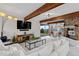 Spacious living room with exposed wood beams and a stone fireplace offers great natural light at 2063 Montane E Dr, Golden, CO 80401